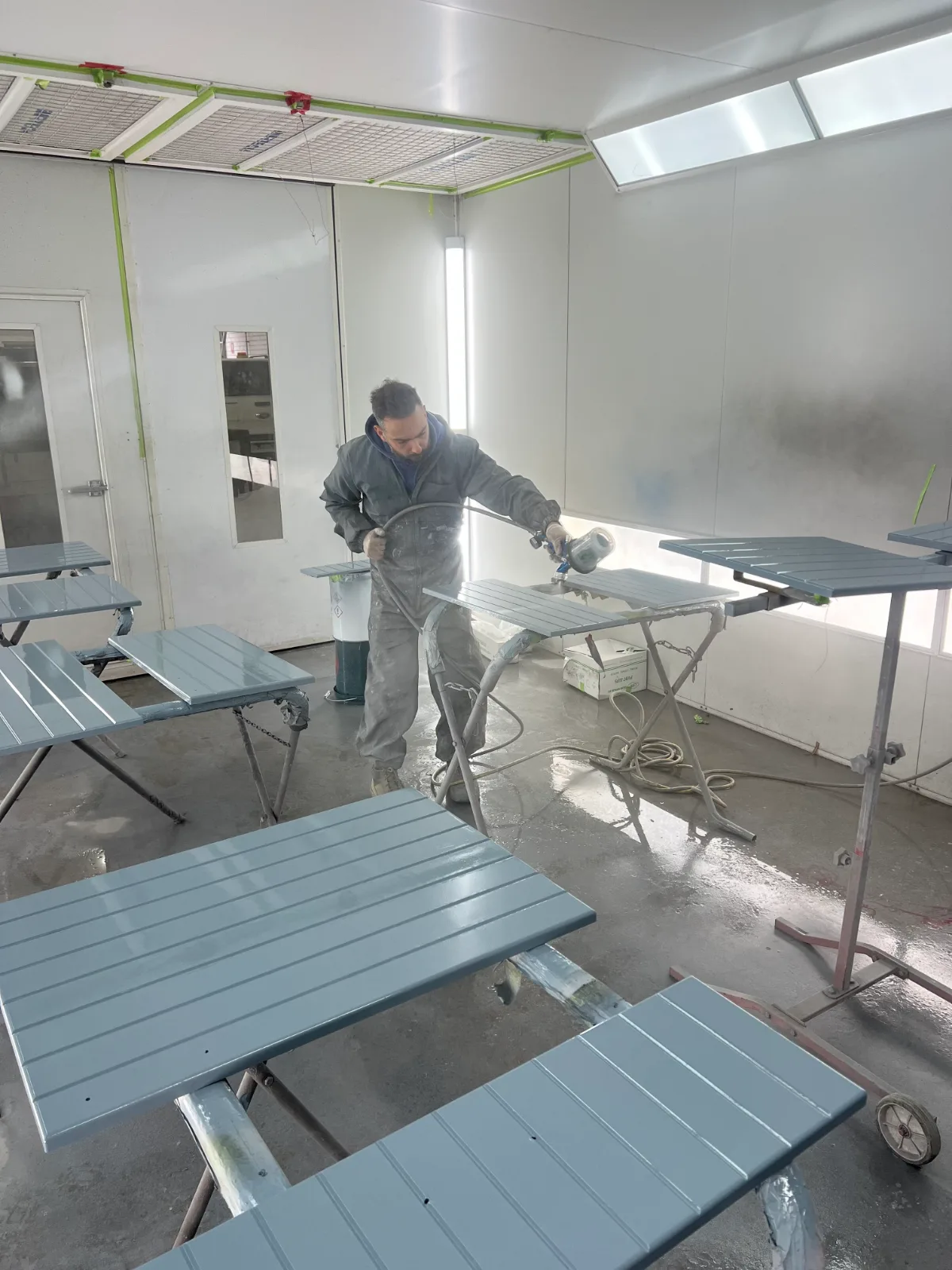Kitchen cabinet doors being spray painted in Jetblack Painting's spray booth