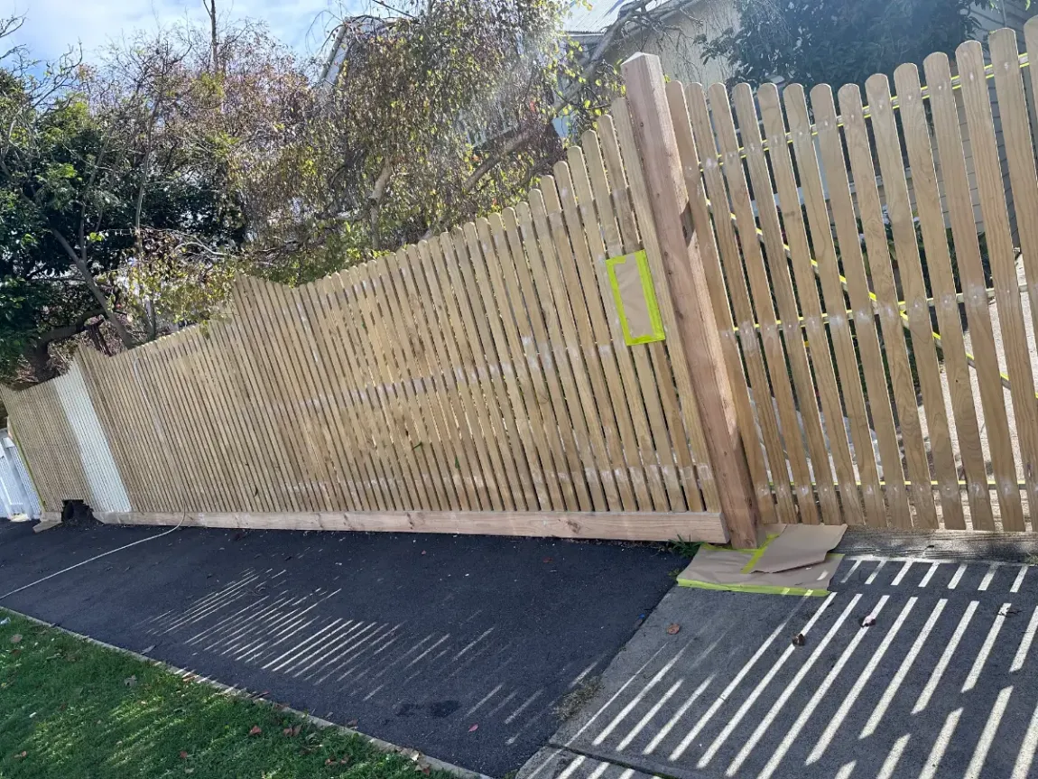 Bare timber picket fence masked up and prepared before painting by Jetblack Painting