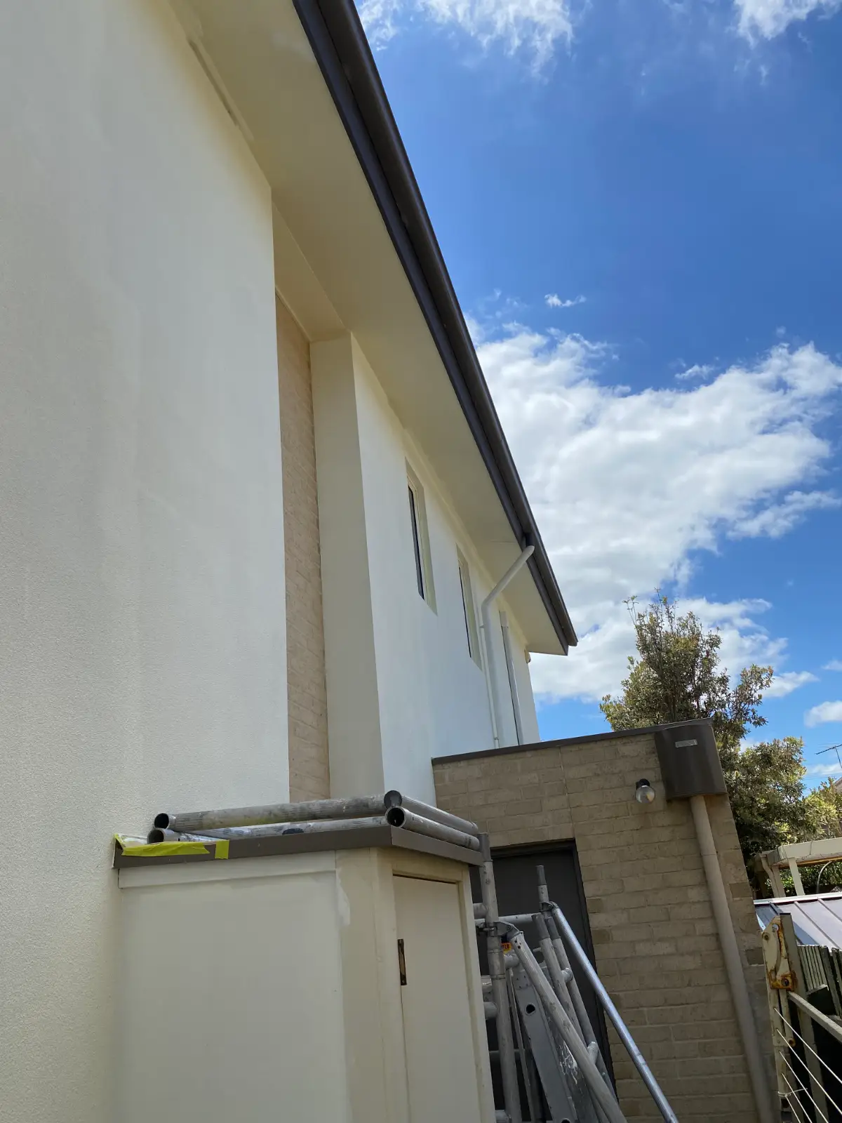 Finished render and gutter line on a two-storey Aspendale house after repainting