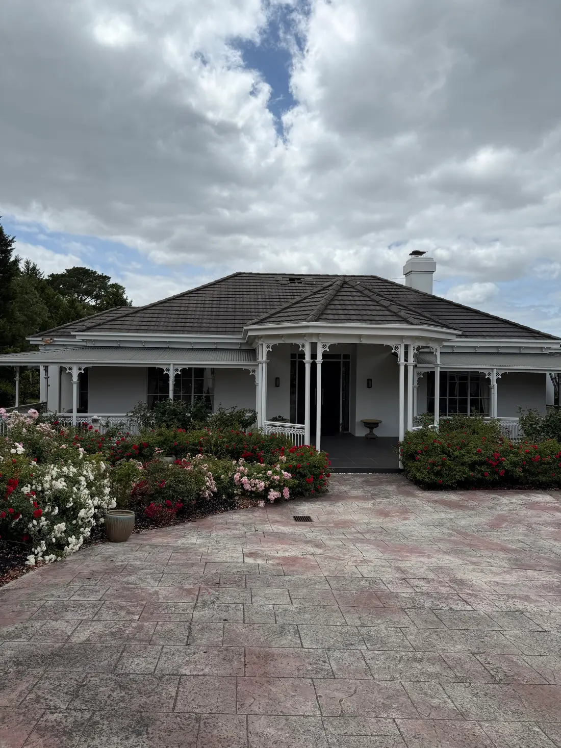 Donvale homestead-style home before roof restoration, with a weathered, unevenly toned tile roof and a gap visible in the ridge capping
