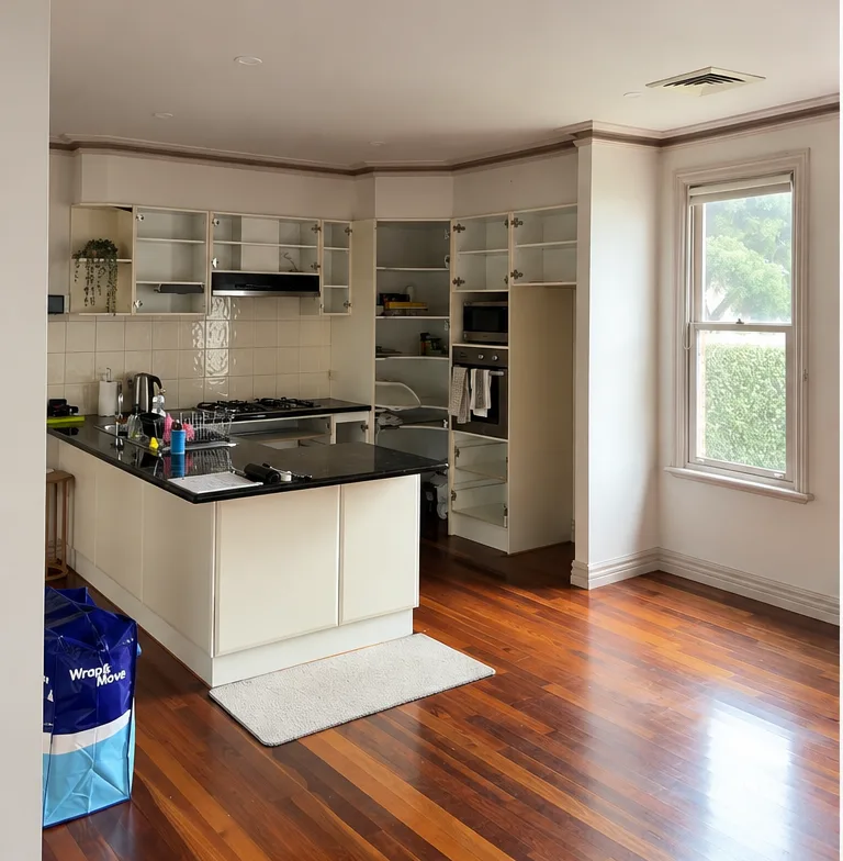 A Malvern kitchen before resurfacing, doors removed from the wall and pantry cabinets and the original cream carcasses left in place