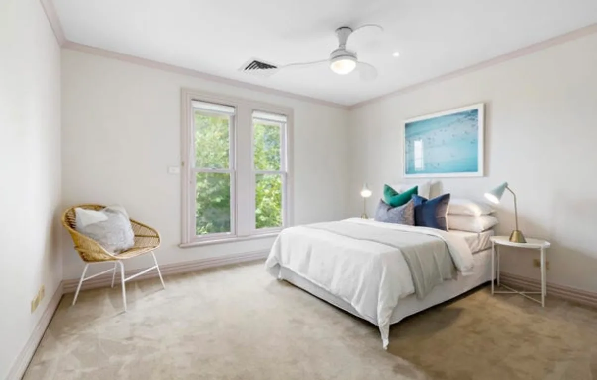 Bedroom in a Malvern home before the pre-sale repaint, mauve cornice, skirtings and double-hung window frames