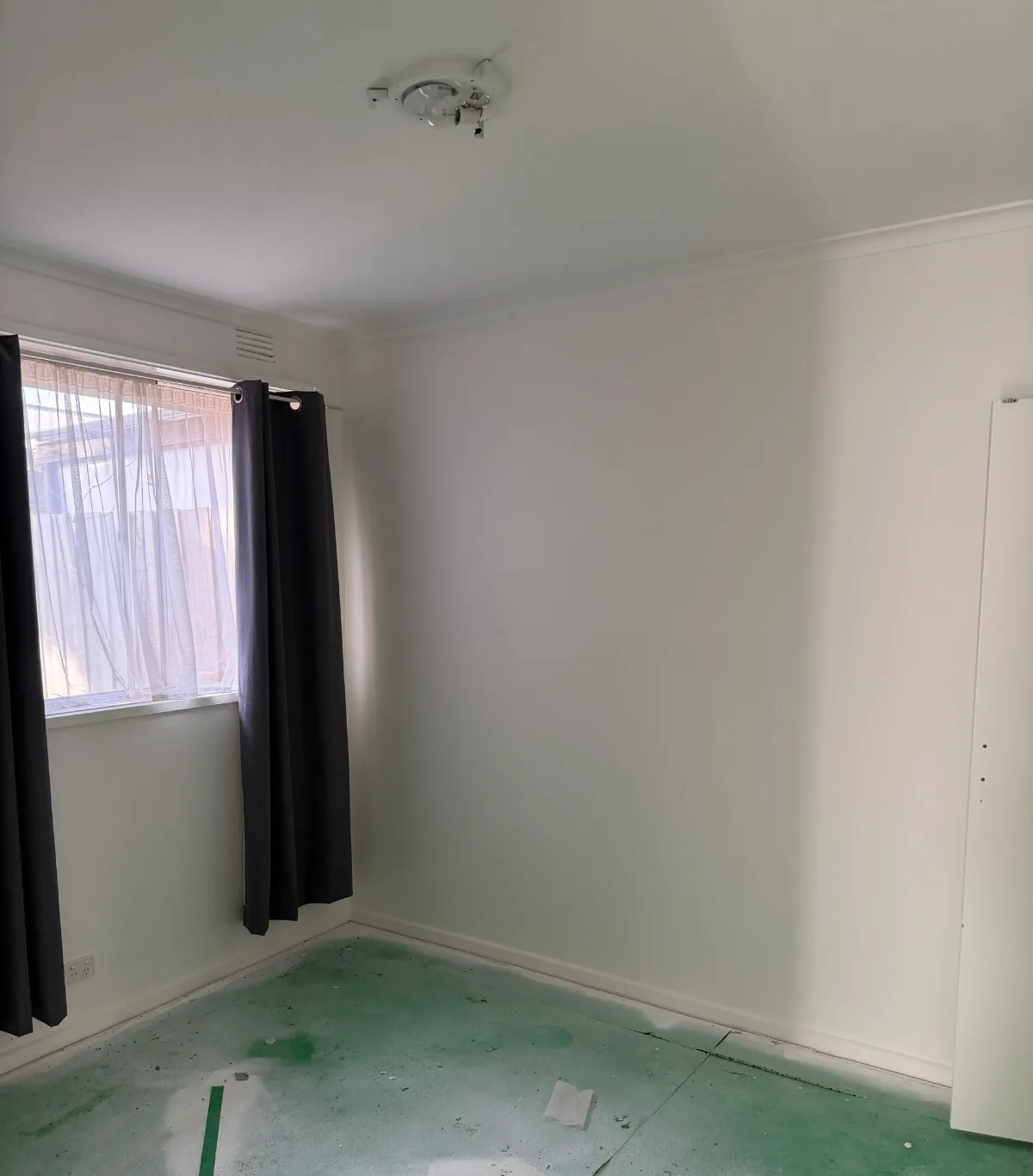 Empty bedroom in the Mordialloc rental after painting, with white walls, ceiling, cornice and skirting